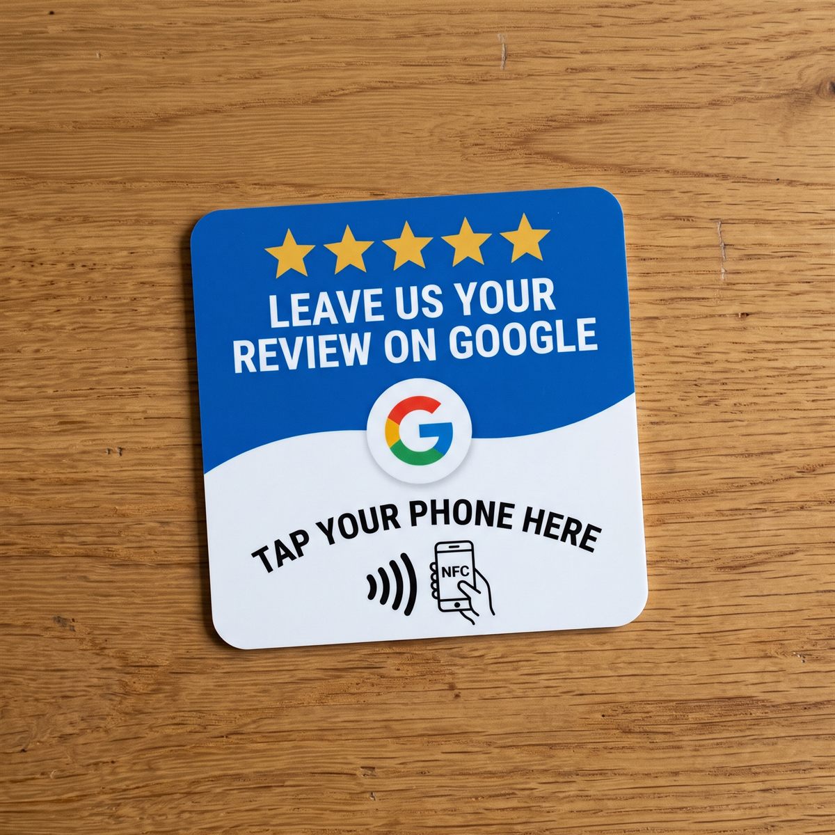 Taptic tap-to-review NFC card in blue and white, lying on a wooden table